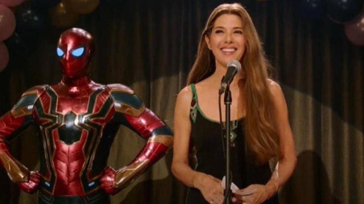 Marisa Tomei stands behind a mic with Spider-Man