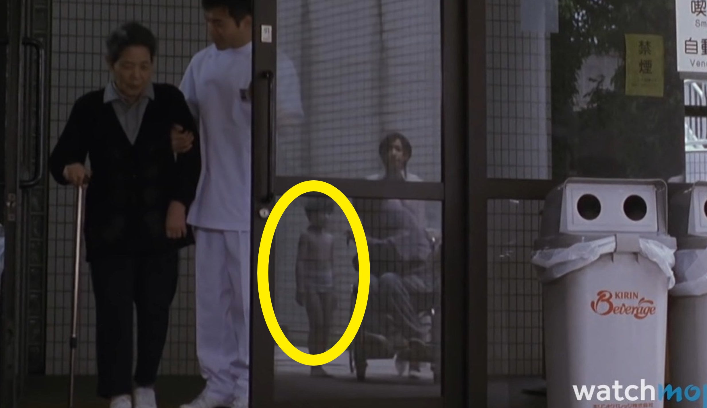 Saito seen in the reflection of a glass door with Toshio in &quot;Ju-on: The Grudge&quot;