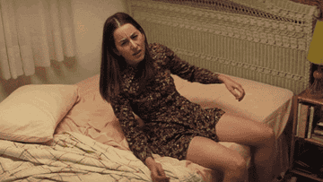 Danielle Haim falling frustratingly on bed in Licorice Pizza