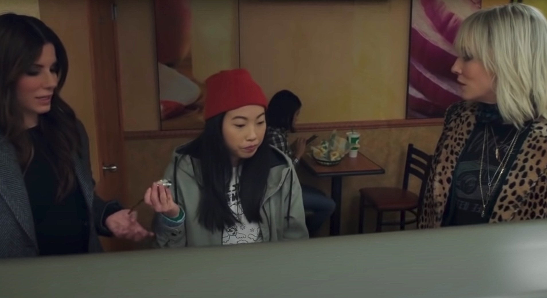 Scene from &quot;Ocean&#x27;s Eight,&quot; with Sandra Bullock, Awkwafina, and Cate Blanchett standing in a diner
