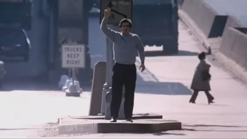 Damien Karras waving his arm in the street in &quot;The Exorcist&quot;