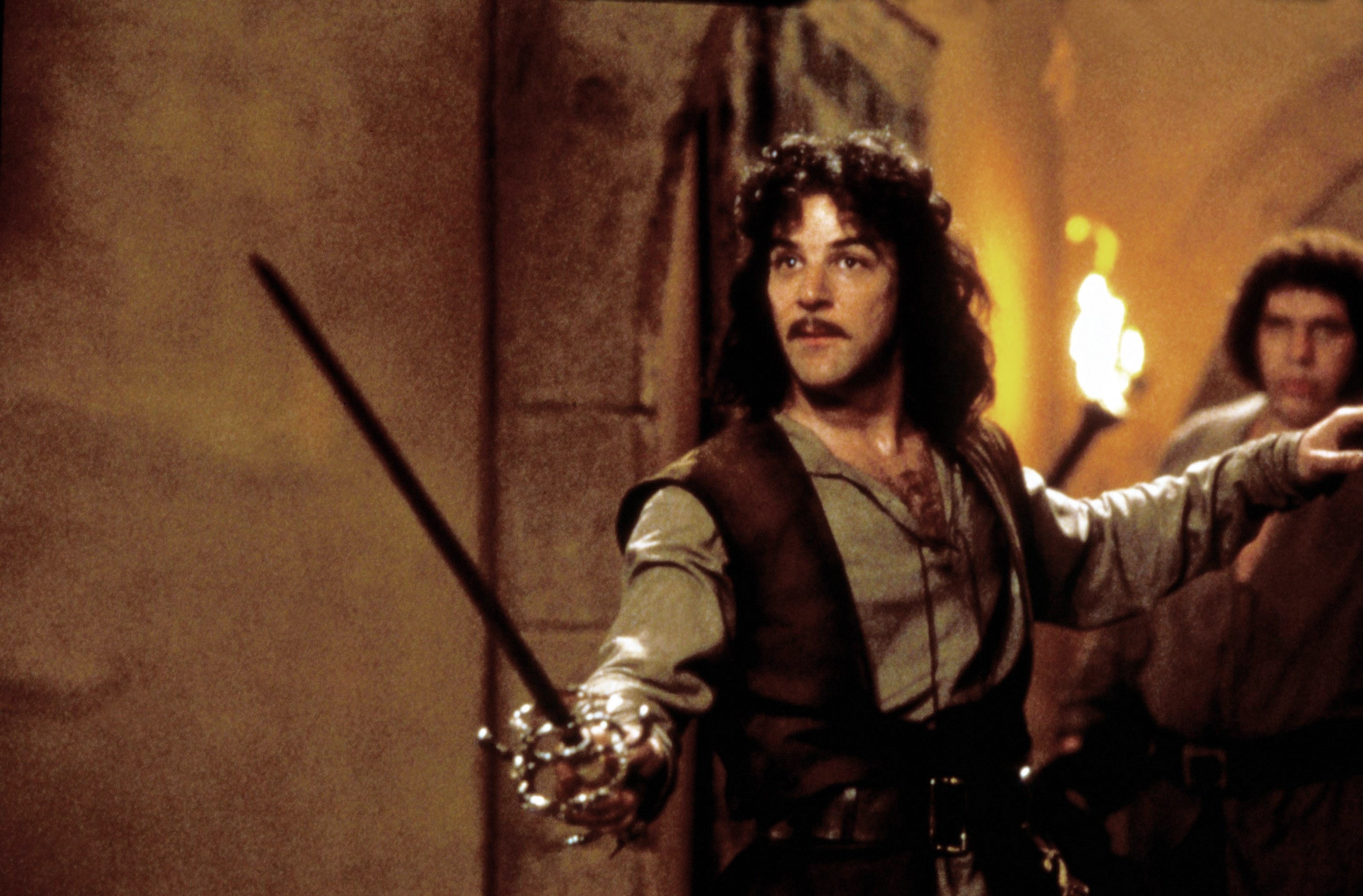 Mandy Patkin holding up a sword to fight