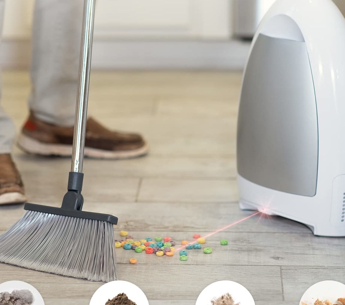 The vacuum about to suck up cereal on the floor