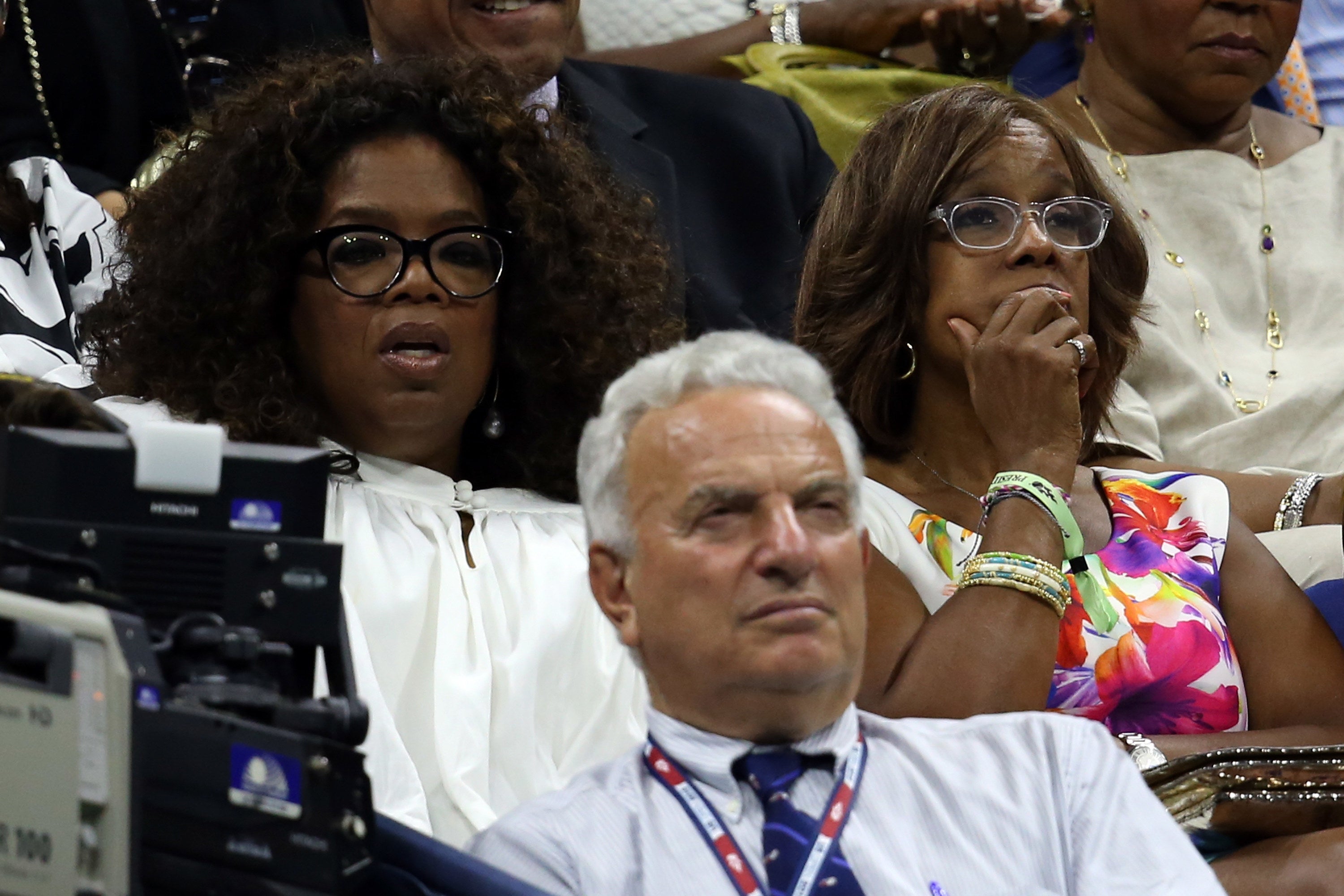Oprah and Gayle watch a tennis game in the stands