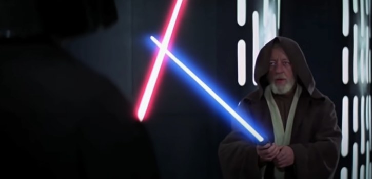 Obi-Wan holds blue lightsaber against a red lightsaber