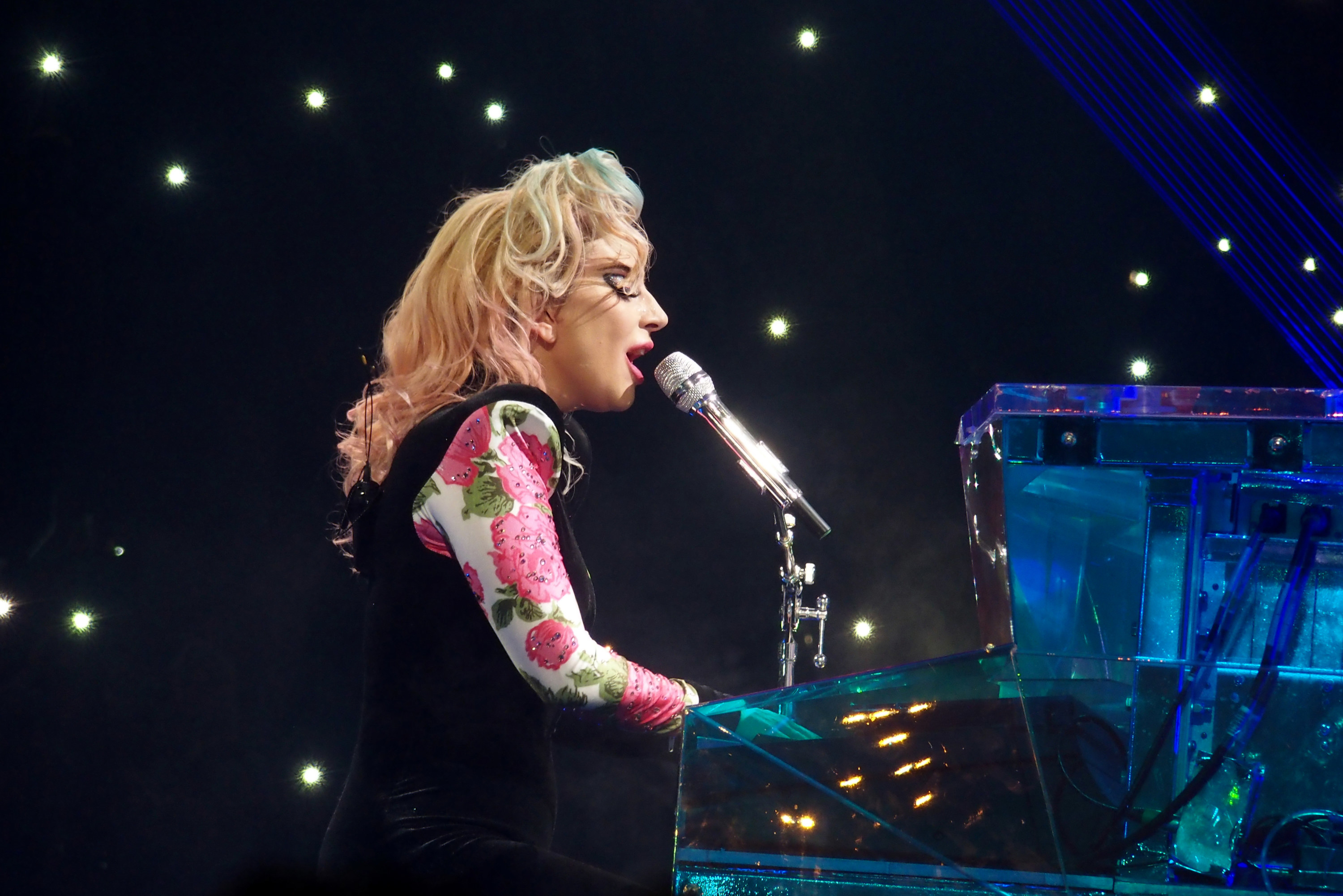 Lady Gaga on stage playing a piano