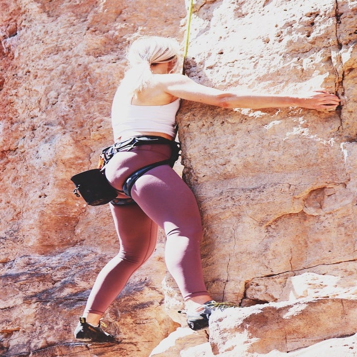 a reviewer wearing the leggings while rock climbing