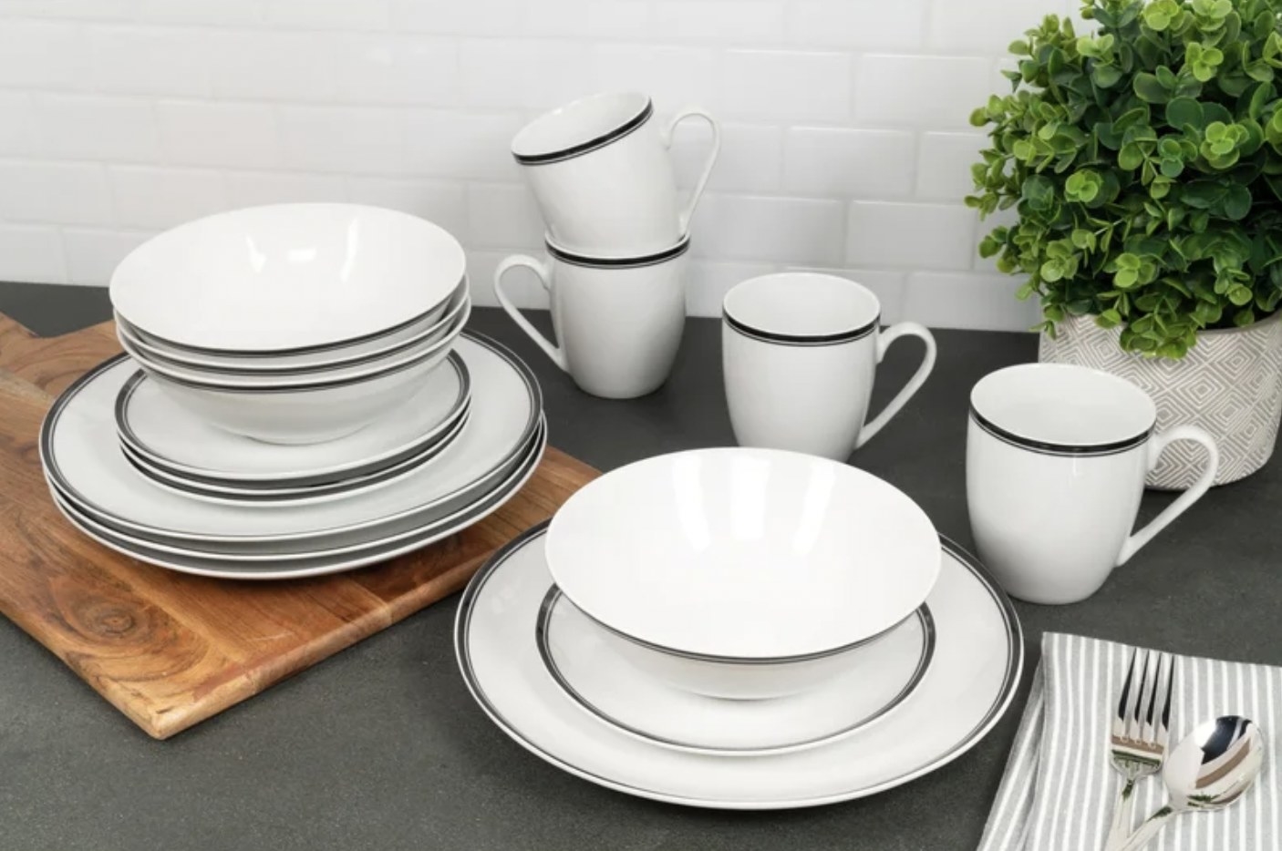 the white dishes with grey trim