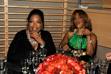 Oprah and Gayle sit at a table together