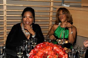 Oprah and Gayle sit at a table together