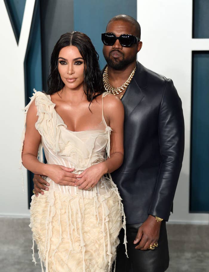 Kim Kardashian wears a tank top strap fringe dress and Kanye West wears an all leather suit