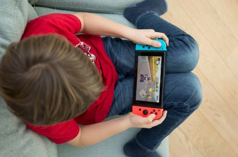 a kid playing a hand held game