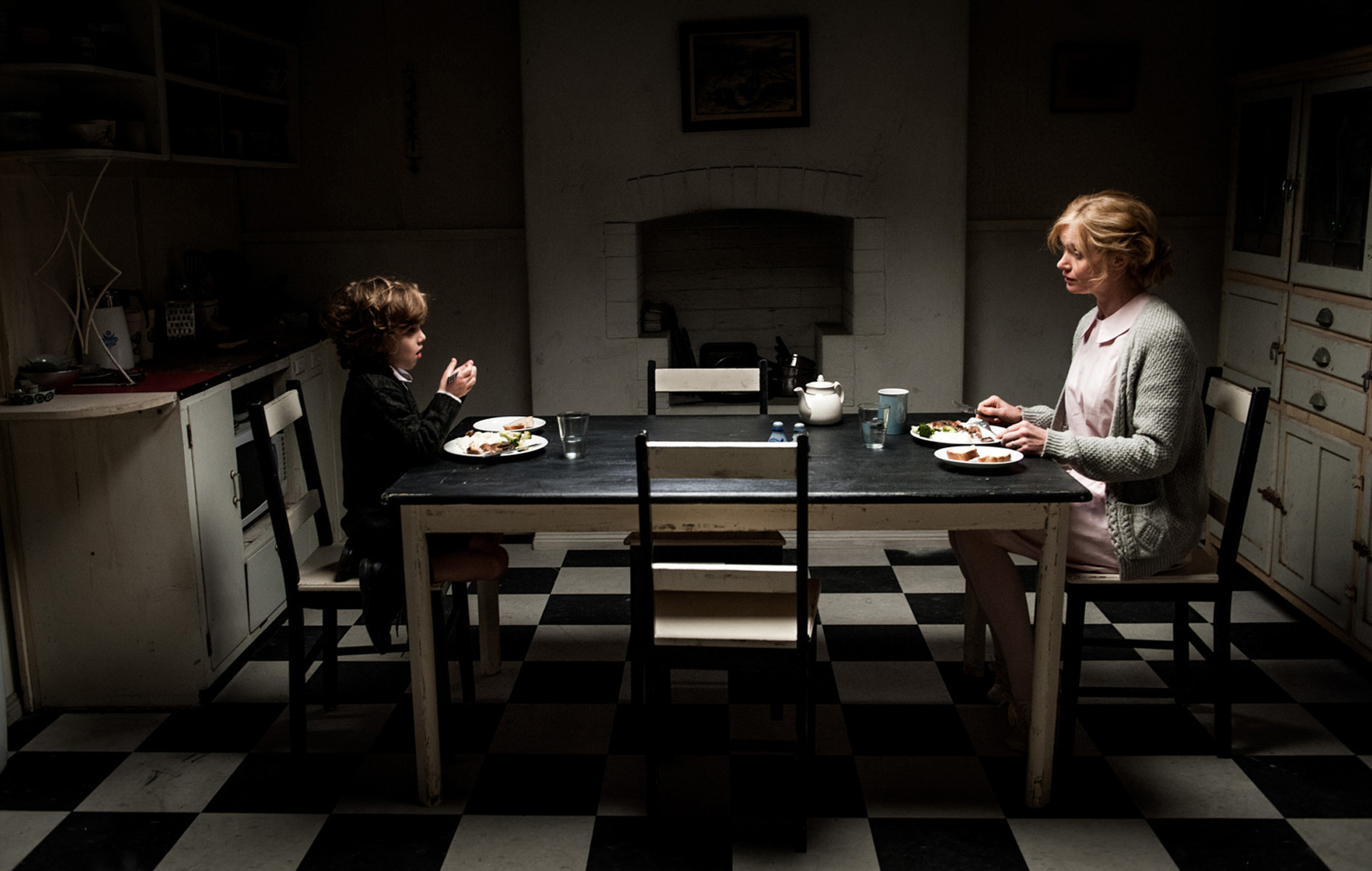 Noah Wiseman and Essie Davis sit across the table from each other