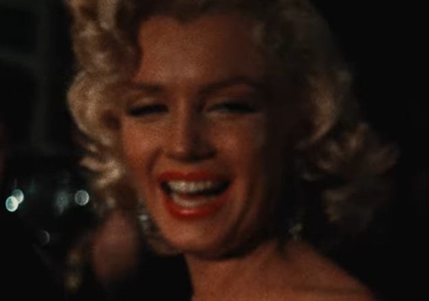 Marilyn Monroe smiles at an event