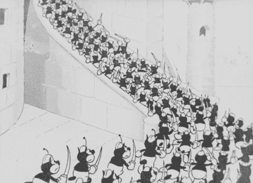 Footage from an old black and white film featuring a mob of angry villagers marching with torches
