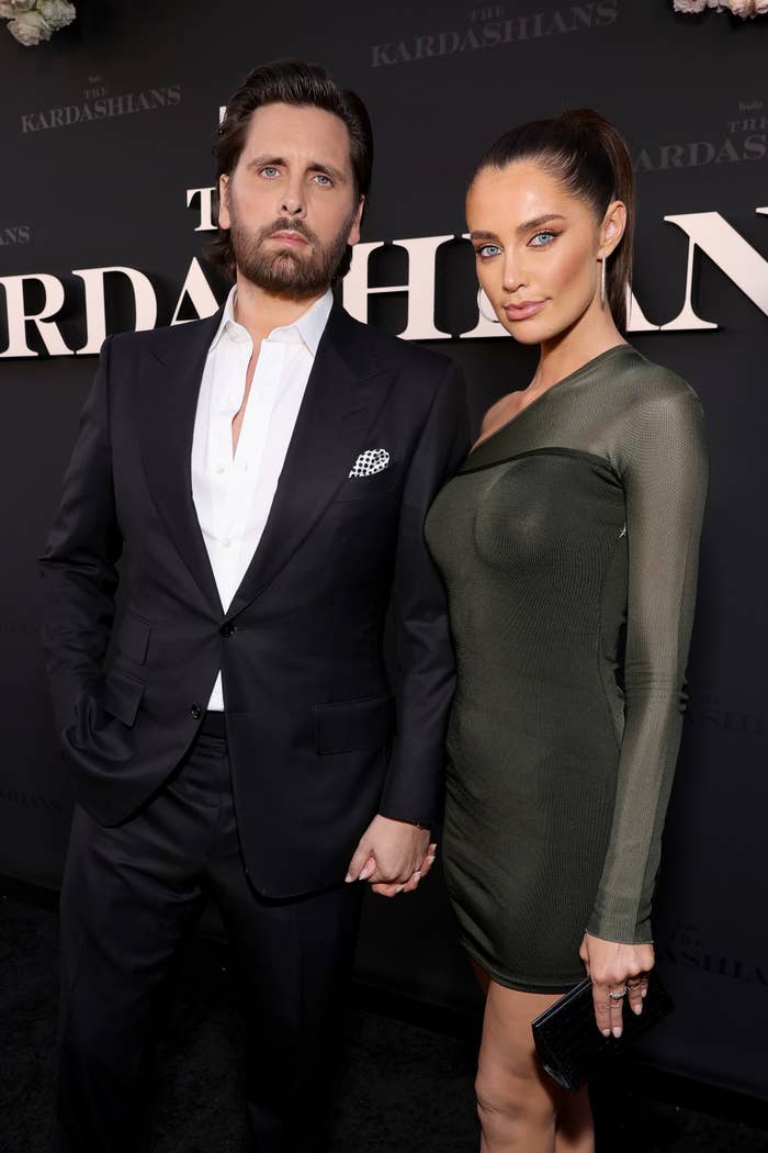 Scott and Rebecca holding hands on the red carpet