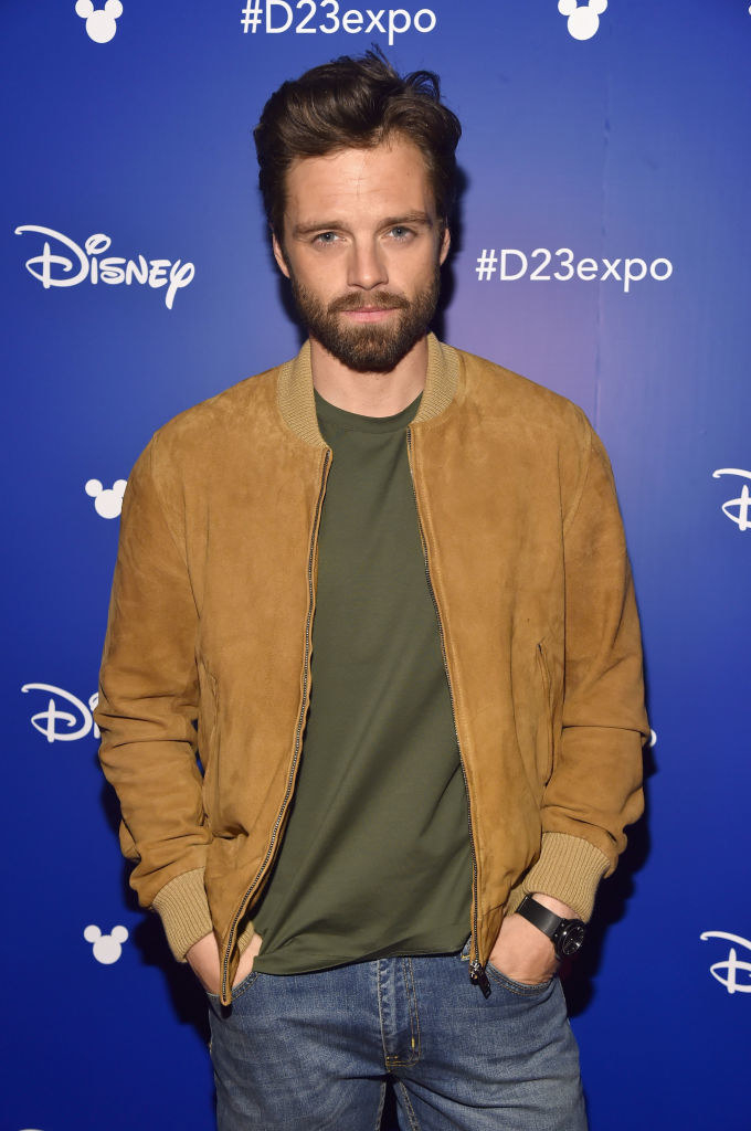 Sebastian in jeans with beard and mustache