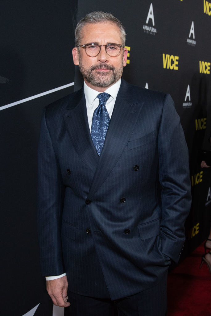 Bespectacled Steve in a suit and tie, with beard and mustache