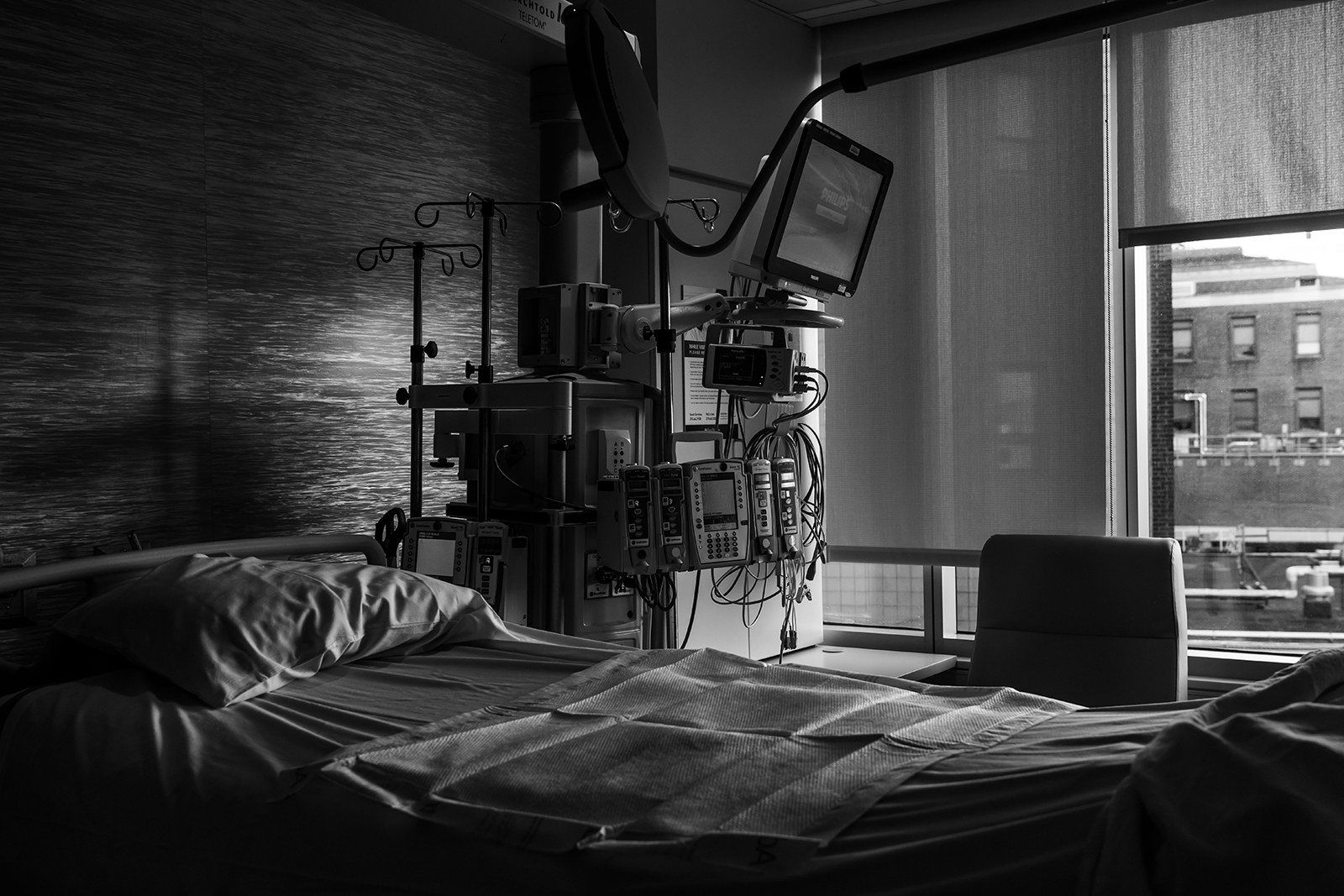 a bed with medical equipment surrounding it