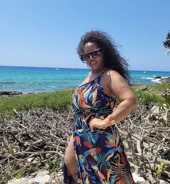 reviewer wearing the tropical print dress
