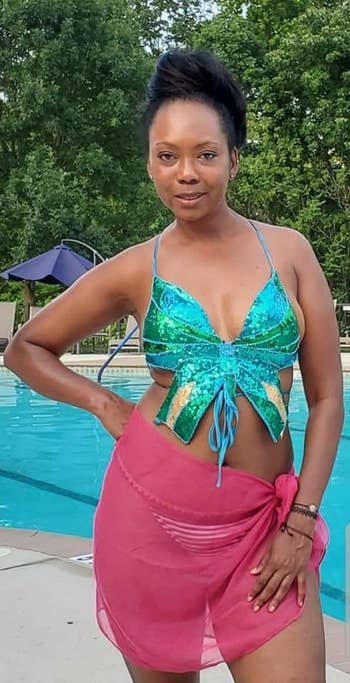 a reviewer wearing the butterfly top in green