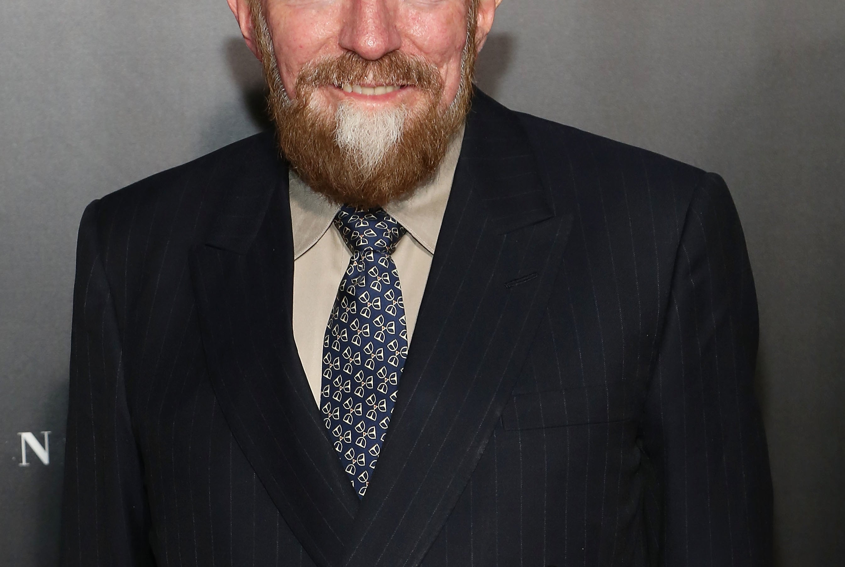 Dr. Kip Thorne stands in front of a poster for Interstellar