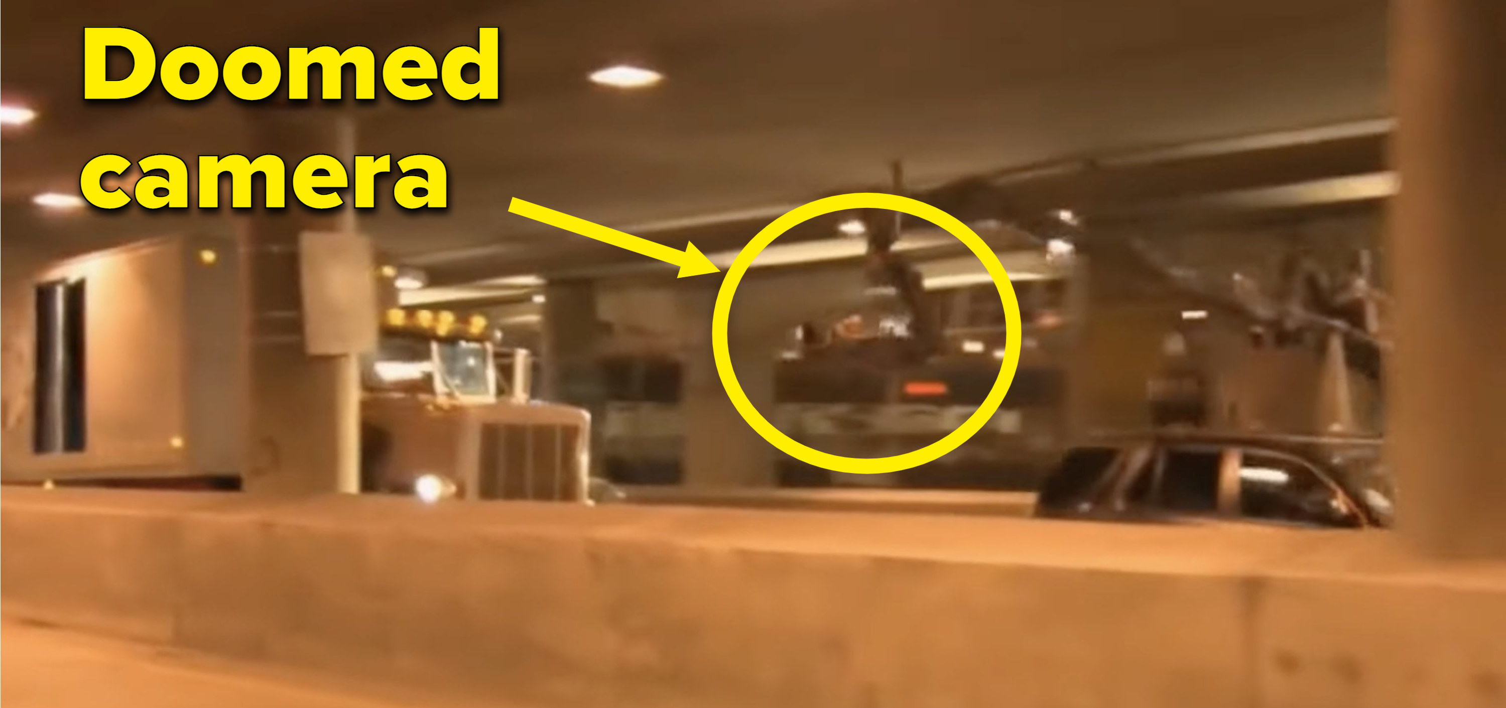 A camera mounted to a car follows a semi-truck through an underpass