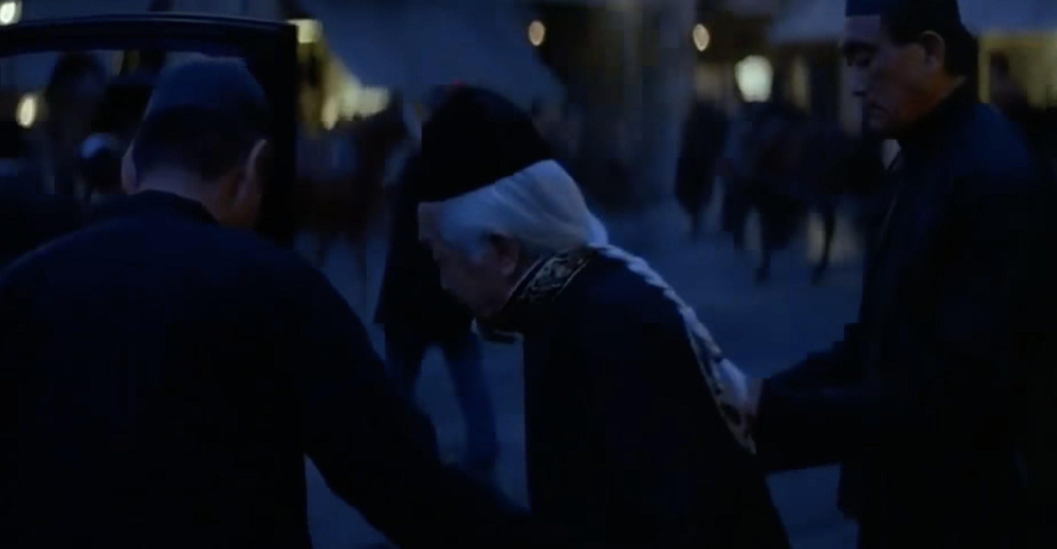 A magician in The Prestige is escorted into a carriage by assistants