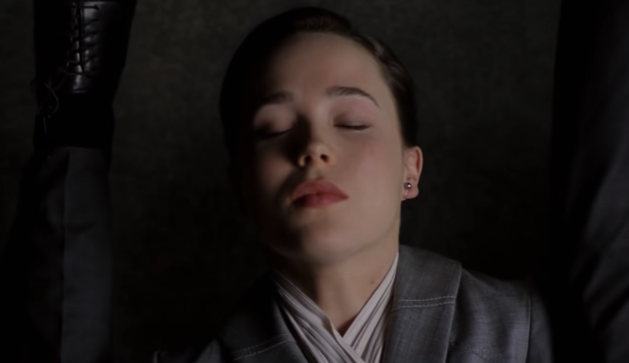Elliott Page as Ariadne, sleeping in an elevator in Inception