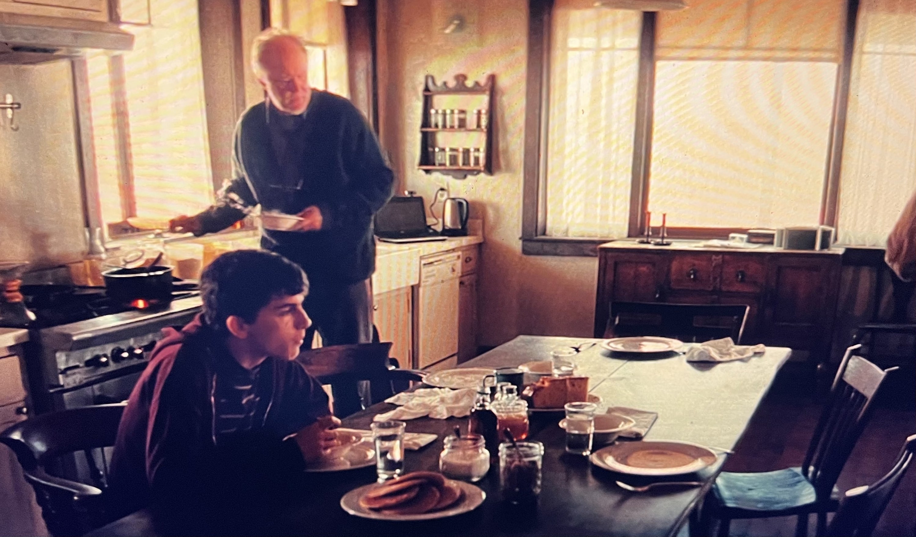 Donald and Tom sit at the kitchen table in Interstellar, breakfast food laid out