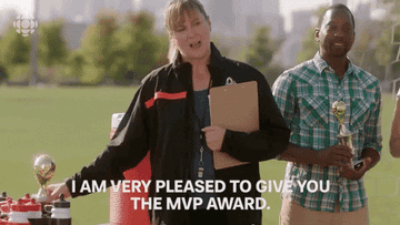 GIF of actor being handed an award and other actor saying, &quot;I am very pleased to give you the MVP award&quot; on the &quot;Baroness von Sketch Show&quot;