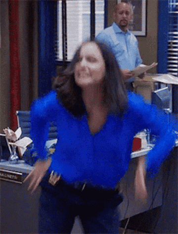 Melissa Fumero as Amy Santiago from &quot;Brooklyn 99&quot; doing a happy dance