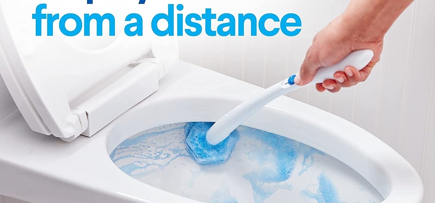 person cleaning a toilet with the wand