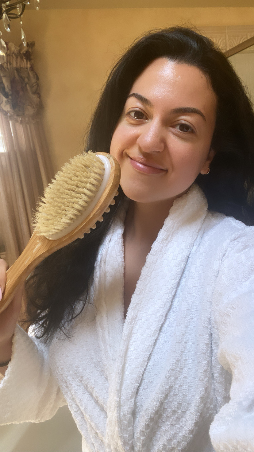 The author smiling and holding her dry brush