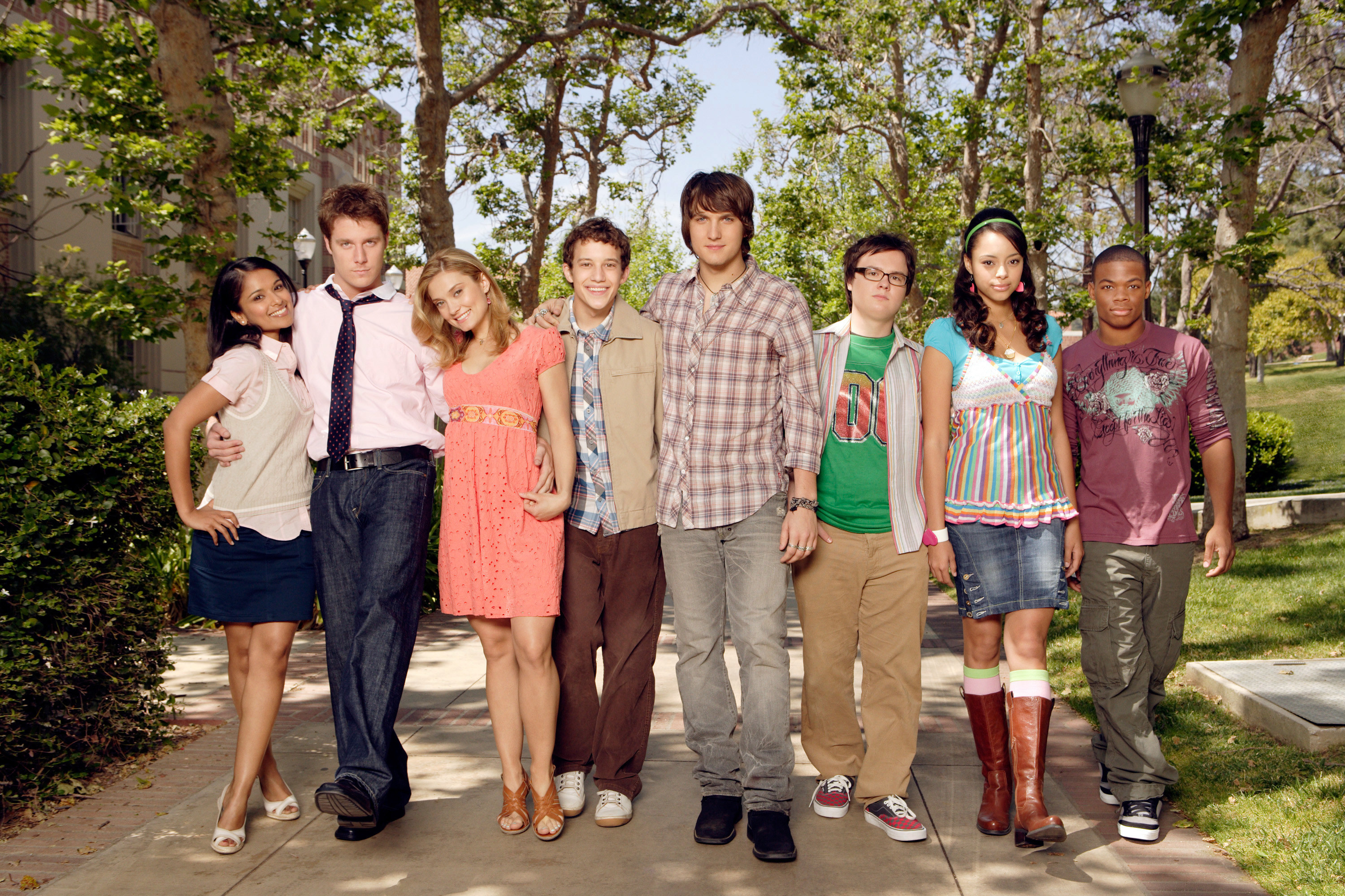 the cast posing on the campus