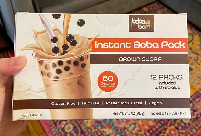 Writer holding up the box of instant boba
