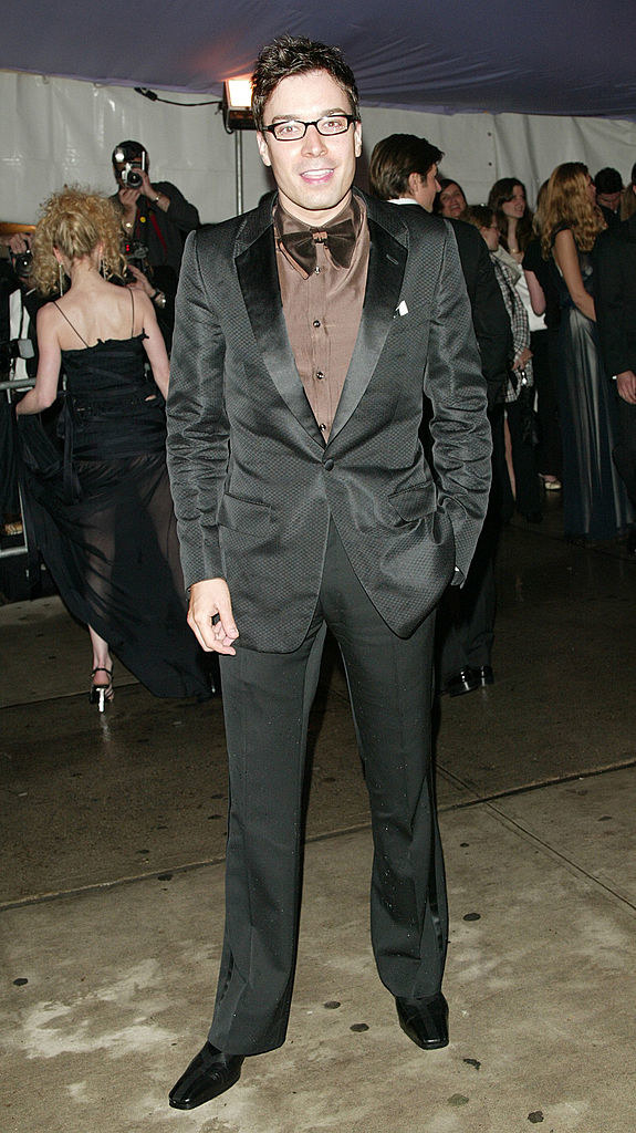 Jimmy in a black suit with brown button-down and bow tie
