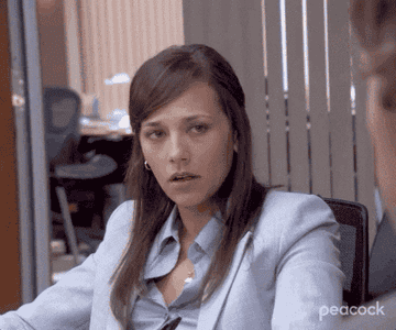 Woman rolling her eyes and biting her lip in a meeting