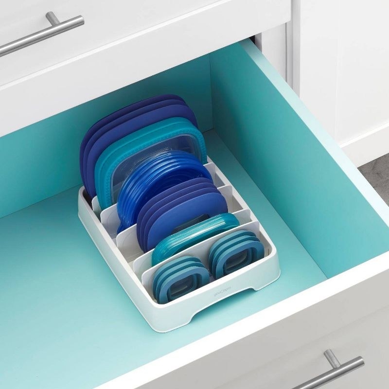white lid organizer holding plastic lids in a drawer