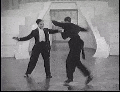 two men in suits tap dance