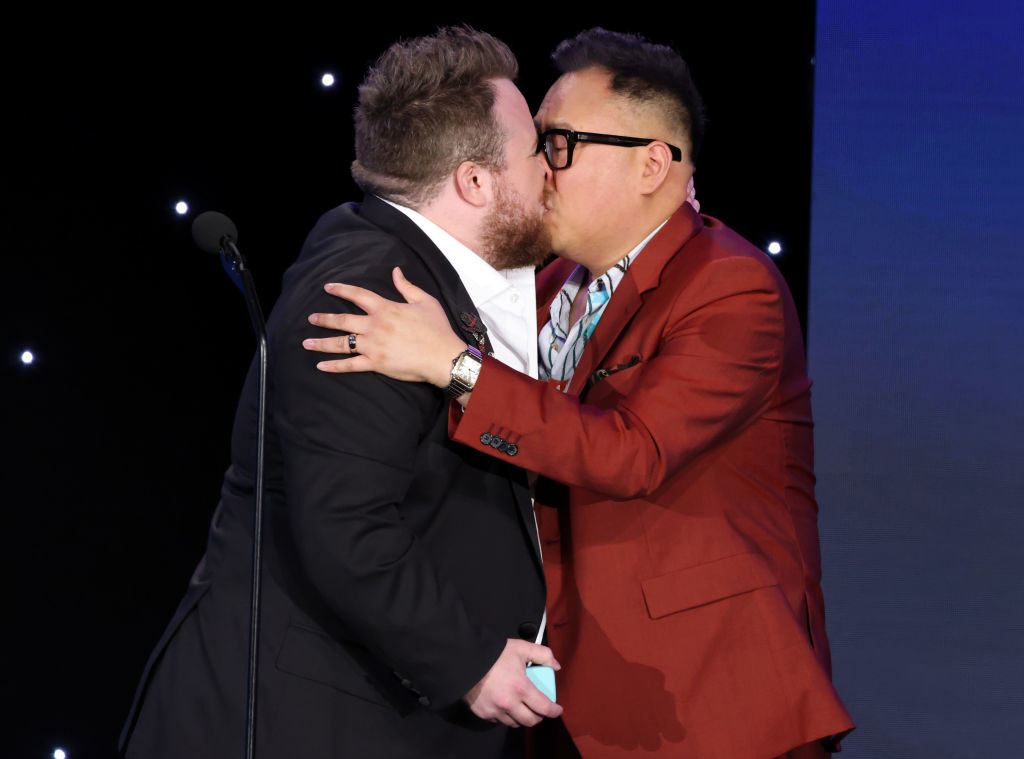 Zeke Smith and Nico Santos kissing at the GLAAD Awards
