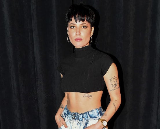 Halsey standing in front of a black curtain