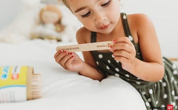 A child reading the chore stick