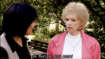 A white, blonde woman looking at another woman and saying, &quot;Oh Marion, you boob.&quot;