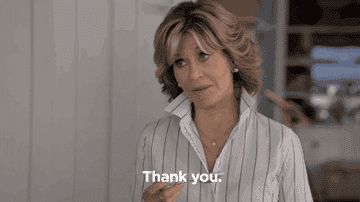 A woman with short hair is seen saying &#x27;thank you&#x27;.