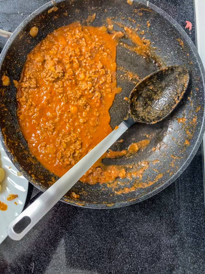 Making Bolognese sauce in a skillet.