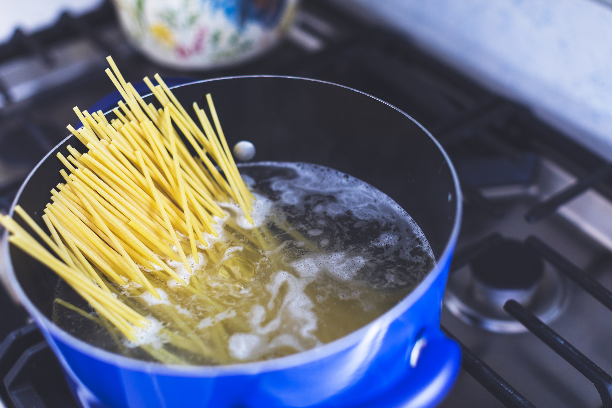 Cooking spaghetti in a pot.
