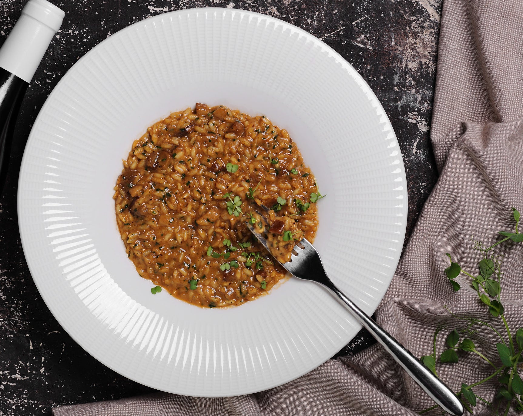 Risotto made with red wine and mushrooms in a bowl.
