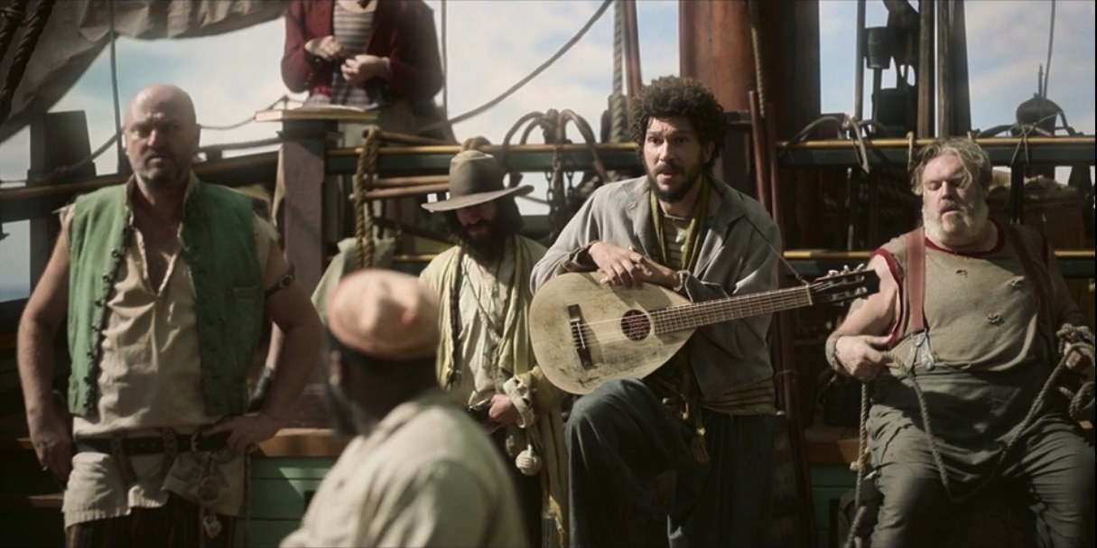Multiple pirates stand around the ship, including Frenchie, who holds a guitar-like instrument.