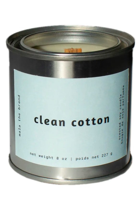 Candle in a metal container with a blue label